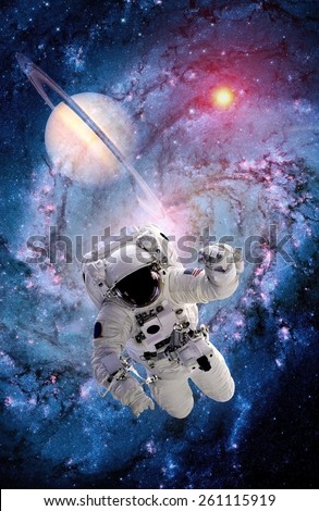Astronaut spaceman power space suit galaxy spiral planet. Elements of this image furnished by NASA.