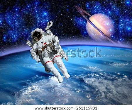 Astronaut spaceman space suit saturn planet earth. Elements of this image furnished by NASA.