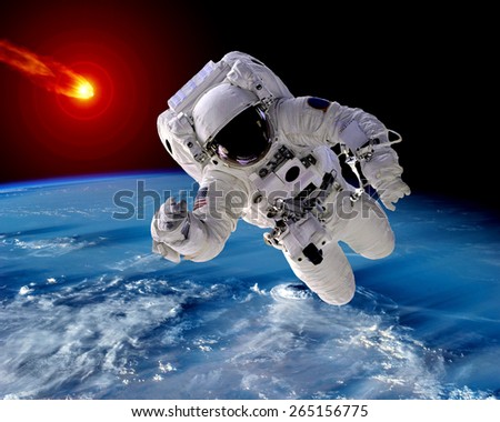 Astronaut spaceman Earth meteor asteroid meteorite space. Elements of this image furnished by NASA.