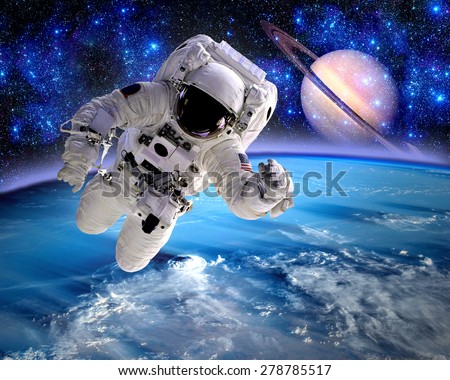 Astronaut spaceman cosmonaut suit space Saturn planet. Elements of this image furnished by NASA.