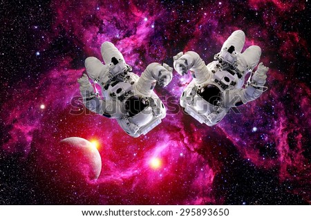 Two astronauts spacemen suit outer space planet gravity universe. Elements of this image furnished by NASA.