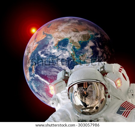 Astronaut spaceman isolated helmet outer space earth globe sunrise. Elements of this image furnished by NASA.
