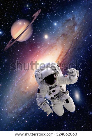 Astronaut spaceman suit outer space saturn planet milky way universe. Elements of this image furnished by NASA.