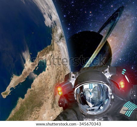 Astronaut helmet et alien extraterrestrial sci fi space earth saturn planet. Elements of this image furnished by NASA.