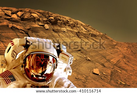 Astronaut spaceman helmet planet Mars surface martian colony space landscape. Elements of this image furnished by NASA.