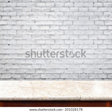 empty marble table and blur white brick wall in background. product display template.