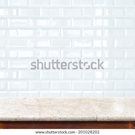 Empty marble table and ceramic tile brick wall in background. product display template.