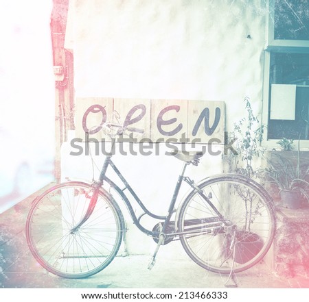 vintage light leak style : open sign and bicycle