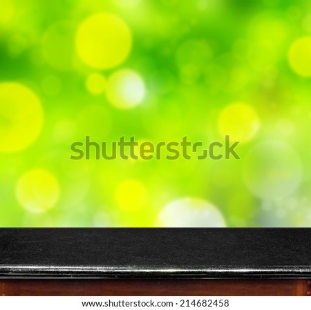 Black Marble table with green bokeh background,empty interior for add your product