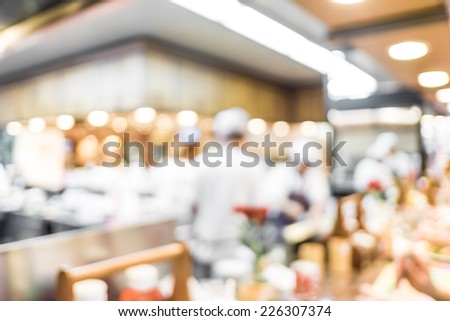 Blurred background : Groups of Chef cooking in the open kitchen,customer can see they cooking at food counter, cooking chef with light bokeh