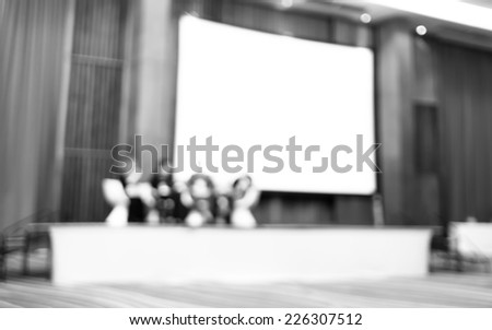 Black and white Blurred background : Speaker on stage in seminar convention hall