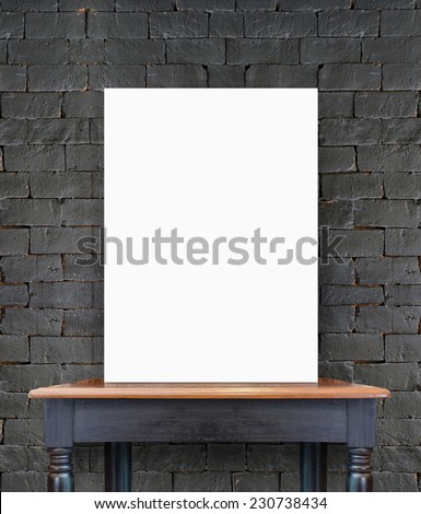 Blank white poster banner standing on vintage wooden table at black brick wall, Mock up template for present business concept.