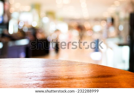 Empty round table top at store blurred background with bokeh light,Template mock up for display of your product.