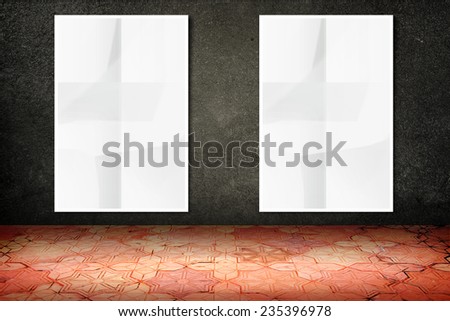 Empty room with hanging blank crumpled white poster at black stone wall and vintage pattern brick floor,Template Mock up for display of your content