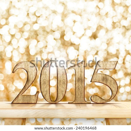 2015 year wood number  on modern wooden table with sparkling bokeh light wall,Template that leave space for your content
