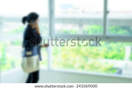 Blurred background : woman talk on phone at condominium room