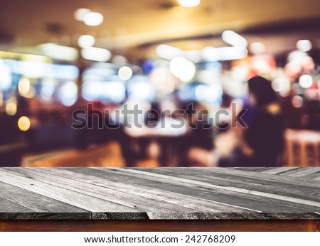 Empty wood table top with restaurant blur with bokeh background,Product display template