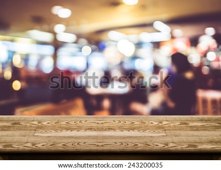 Empty dark wood table top with coffee shop blur with bokeh background,Product display template.