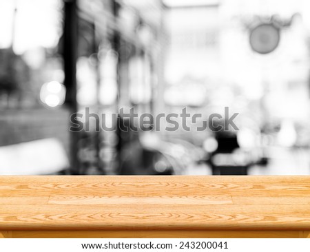 Empty light wood table top with coffee shop blur with bokeh background,Product display template.