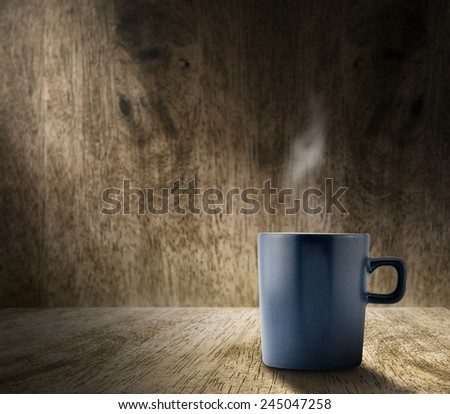 Lighting from window with hot blue coffee cup in hardwood room with blur wood wall,template adding content