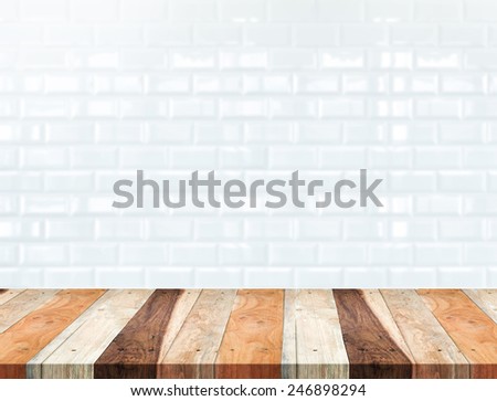 Empty tropical wood table and blur white ceramic tile brick wall in background,Mock up template for display of your product
