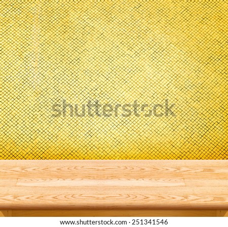 Empty light Wooden Table top at golden mosaic tiles wall,Template mock up for display of your product