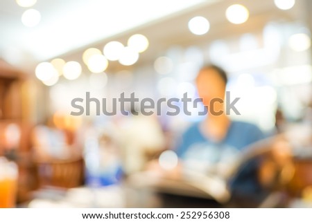 Blurred background : Woman Customer see menu at restaurant blur background with bokeh