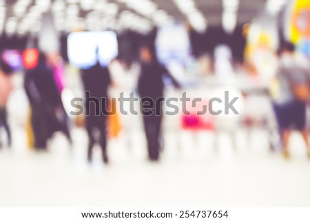 Blur background : passenger airplane waiting for bag at Baggage Claim with bokeh light.