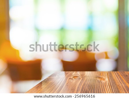 Empty wood table at blurred garden cafe background