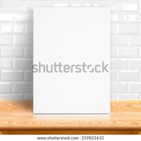 Black White paper poster lean at white ceramic tiles wall and wood table,Template mock up for adding your text
