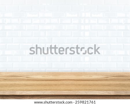 Empty wood table and ceramic tile brick wall in background. product display template