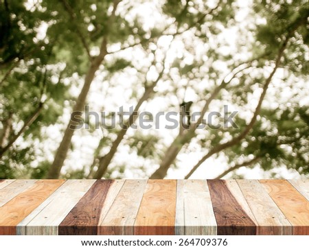 Empty perspective table with blurred green tree forest,Template mock up for display of your product