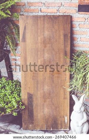 vintage filter : Empty wood sign board on brick wall in front of coffee shop,Template mock up for adding your menu of restaurant.