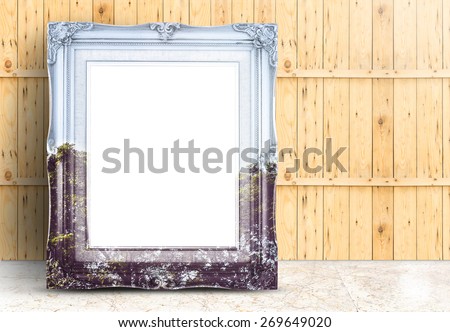 Blank Vintage frame with double exposure of tree landscape image lean on marble floor and plank wooden wall,Template mock up for adding your design