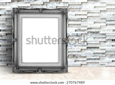Blank black Vintage frame on marble floor and white stone tiles wall,Template mock up for adding your design.