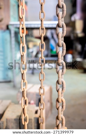 Rustic old grunge chains link in old factory.