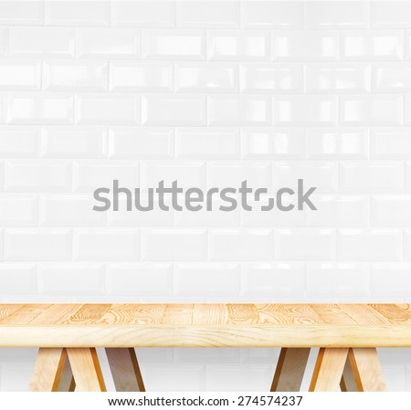 Empty wood modern table and white ceramic tile wall in background,Mock up template for display of your product.