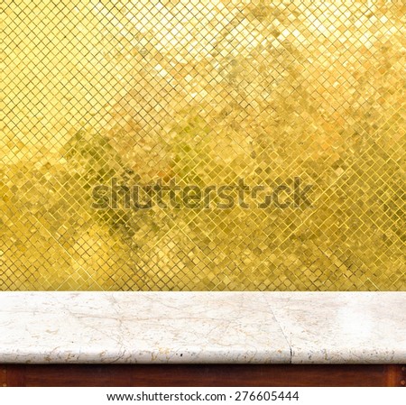 Empty marble table and golden tiles wall in background,product display business template