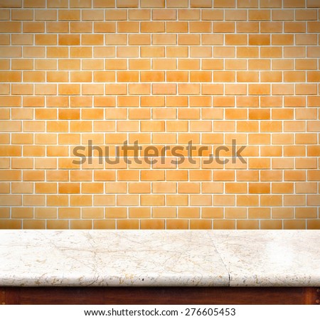 Empty marble table and orange brick wall in background,product display business template