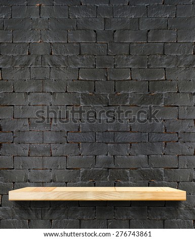 Empty Wooden shelf at black brick wall,Template mock up for display of product,business presentation.