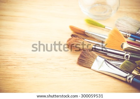 Vintage filter, Group of watercolor brush on wood table ,Copy space for adding your content.