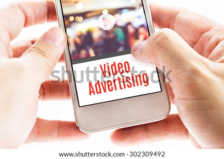 Close up Two hand holding mobile with Video Advertising word, Digital business concept.