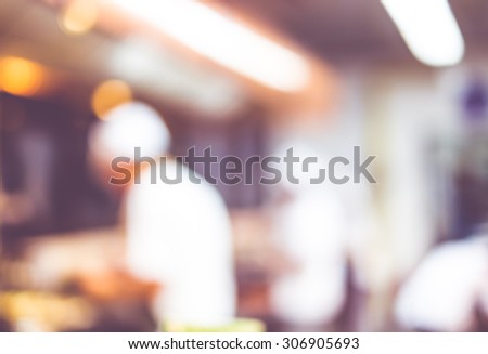 Blurred background : Groups of Chef cooking in the open kitchen,customer can see they cooking at food counter, cooking chef with light bokeh.