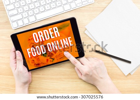 Finger click screen with Order food online word with keyboard on wooden table,Food business design concept