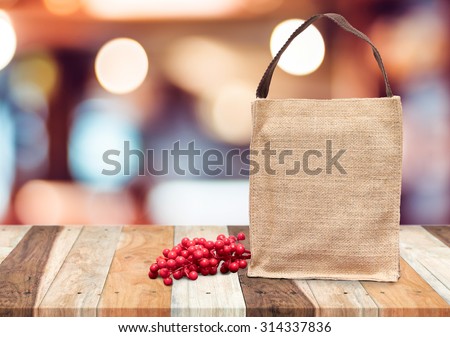 Brown shopping sack bag and cherry fruit on wooden table,mock up for adding your text