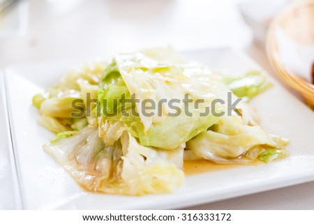 Fried cabbage with Shell oil on white dish,Thai food style