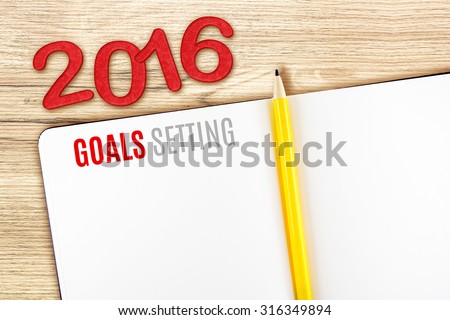 2016 Goals Setting word on notebook lay on wood table,Template mock up for adding your goal.
