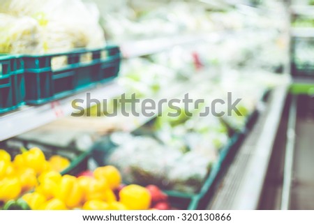 Blurred background : Fresh vegetable on shelf at Supermarket with bokeh light