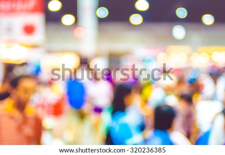 Blurred background: crowd of people in expo fair with bokeh light ,Vintage filter
