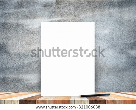Blank white poster leaning at tropical wood table top with dark stone wall,Mock up background for adding content